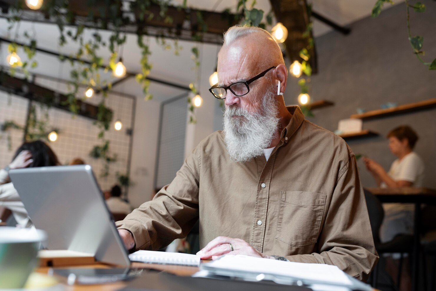 Older man looking at his computer learning affiliate marketing over 60
