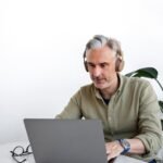 Over 60 year old man working on his computer