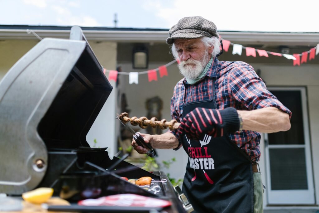 Older man cooking on his barbecue