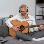 Older man playing guitar over 60