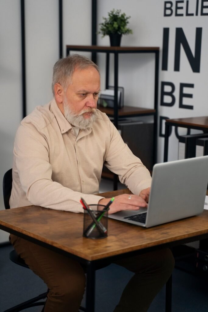Older man on his computer learning affiliate marketing over 60
