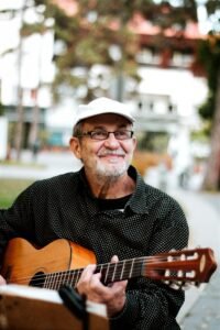 Older man over 60 playing guitar