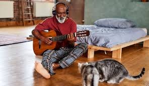 older man over 60 playing guitar part of a blog encouraging men over 60 to learn guitar
