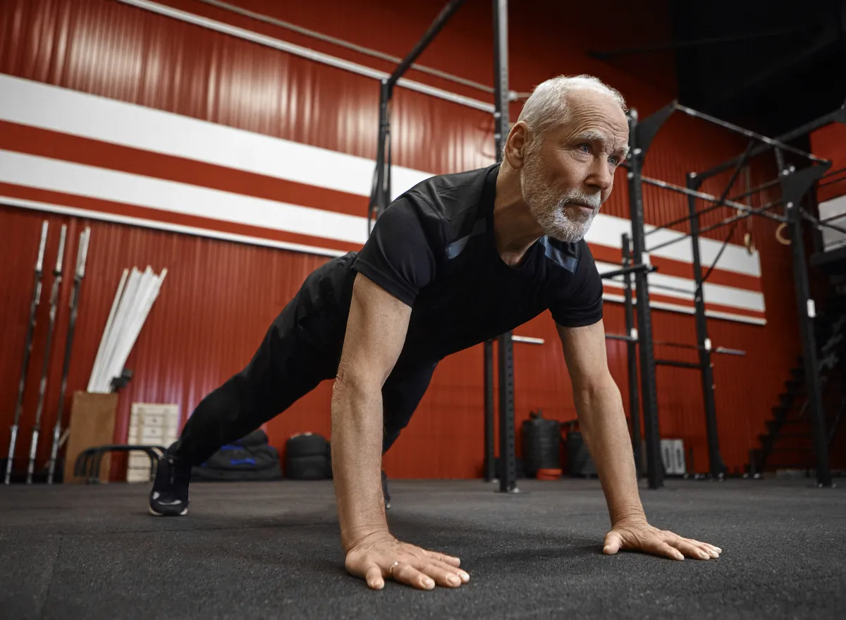 Older man performing pushups at a gym as part of a blog for strength training over 60